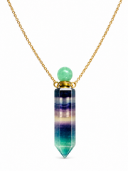A gold chain necklace featuring a vertical faceted crystal pendant with horizontal bands of purple, blue, green, and teal, topped with a smooth light green bead, shown on a white background.