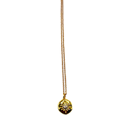 Gold necklace with a round pendant on a white background