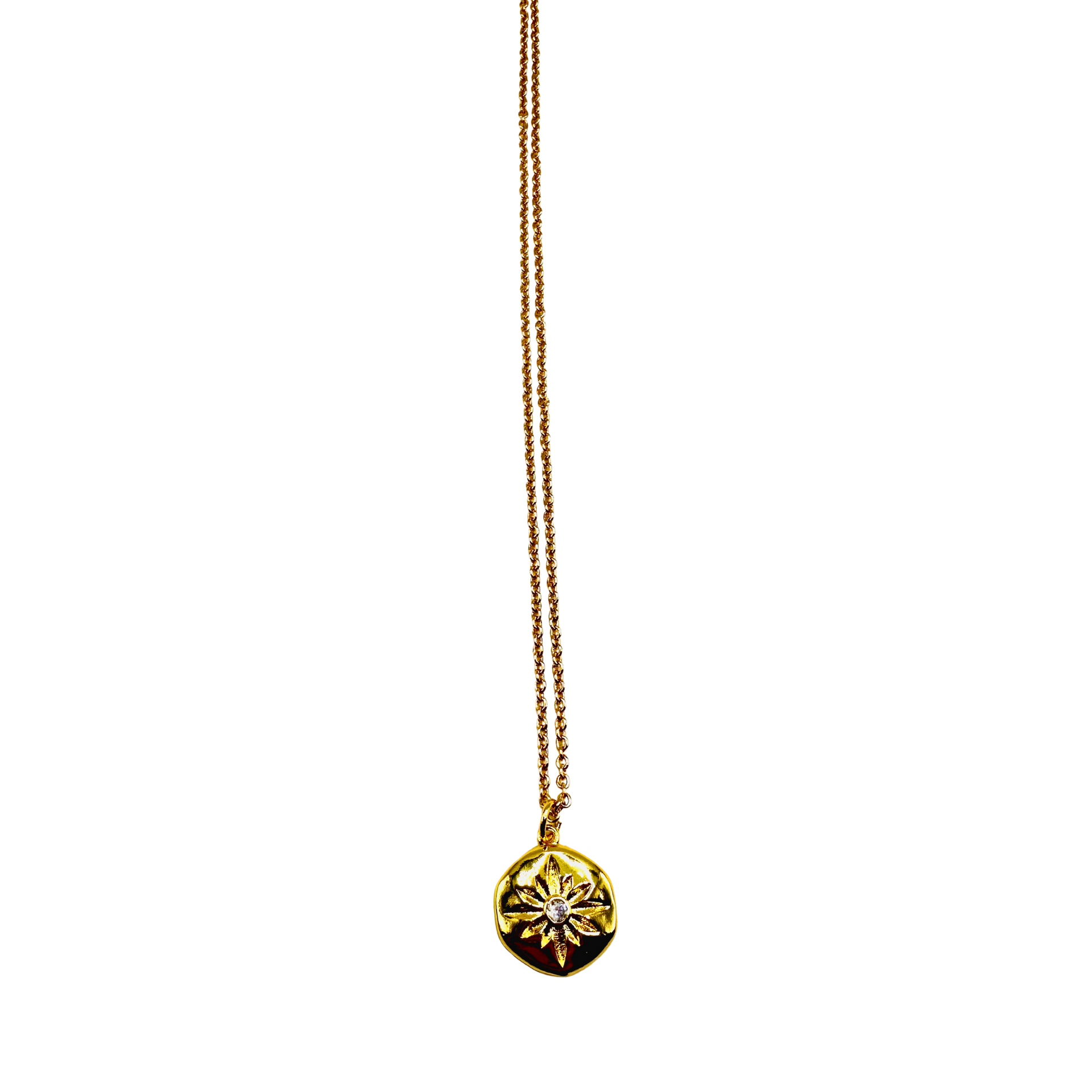 Gold necklace with a round pendant on a white background