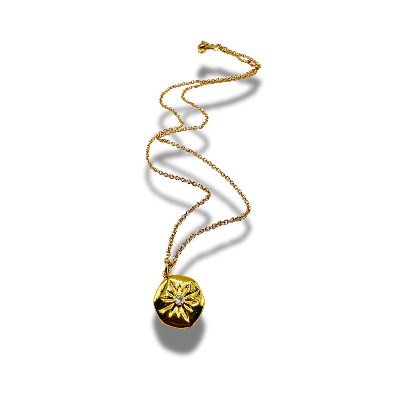 Gold necklace with a round pendant on a white background