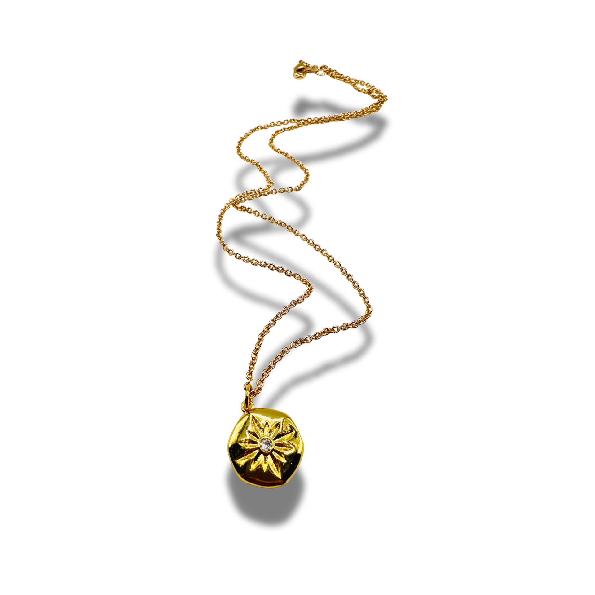 Gold necklace with a round pendant on a white background