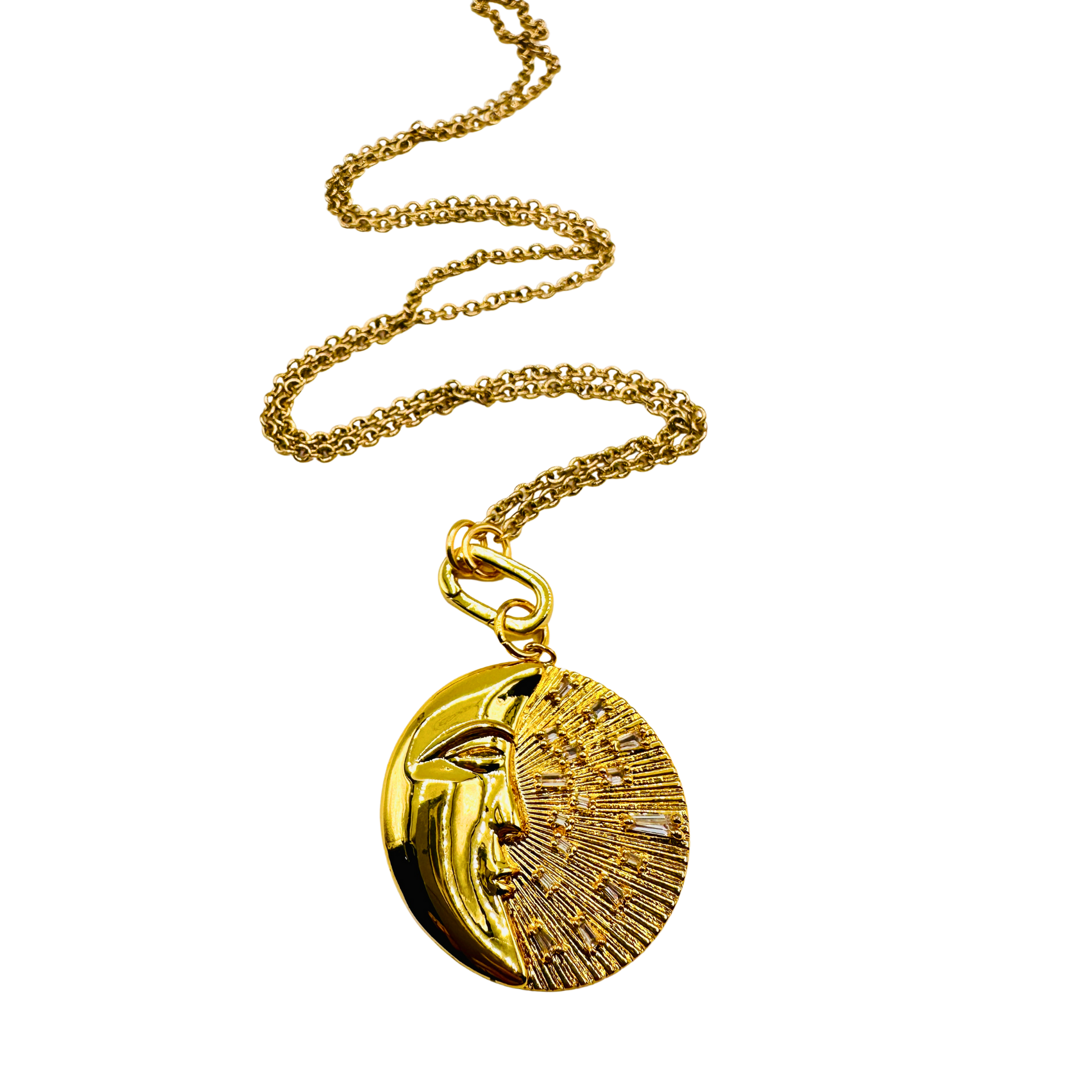 Gold necklace with a face pendant on a white background