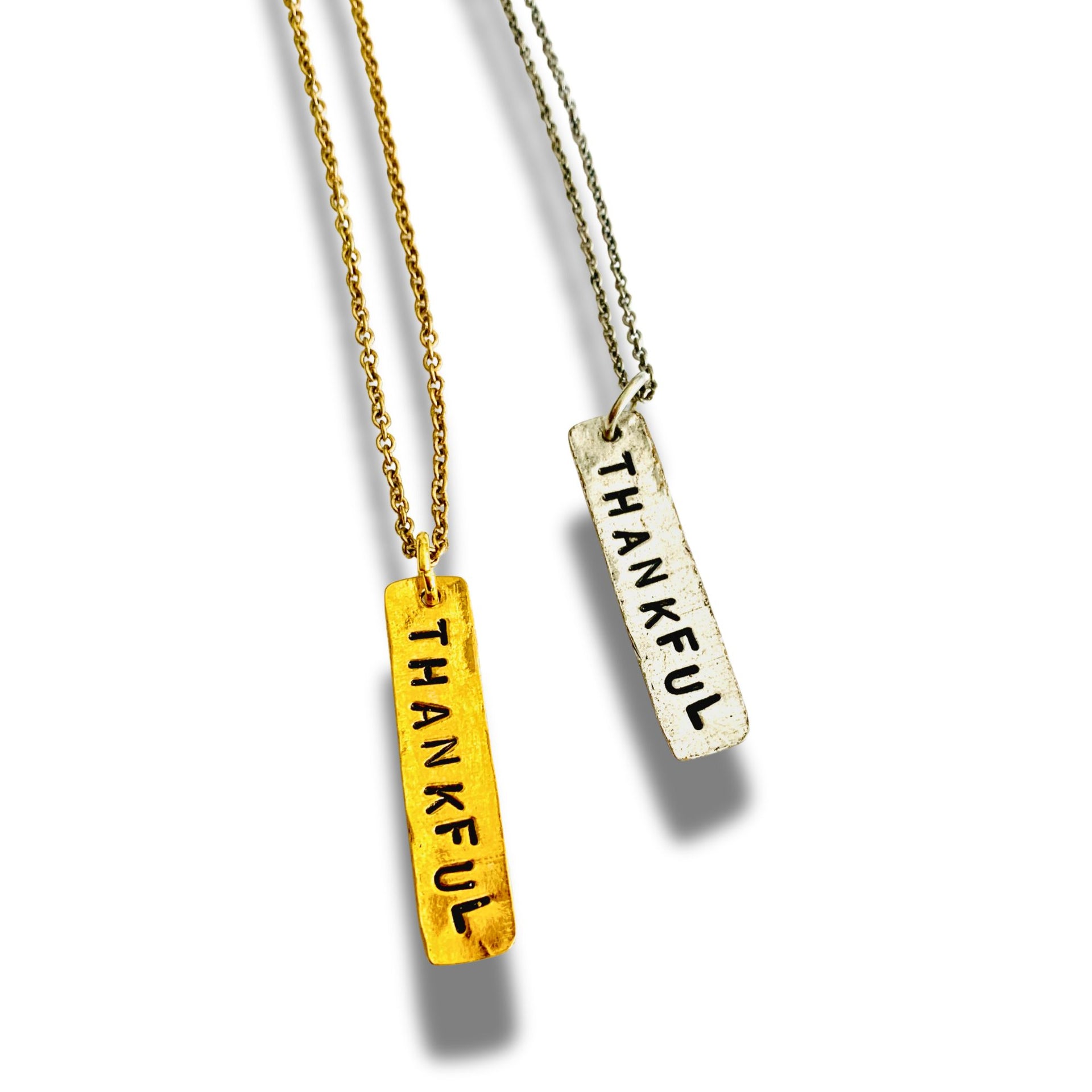 Two necklaces with 'THANKFUL' pendants on a white background