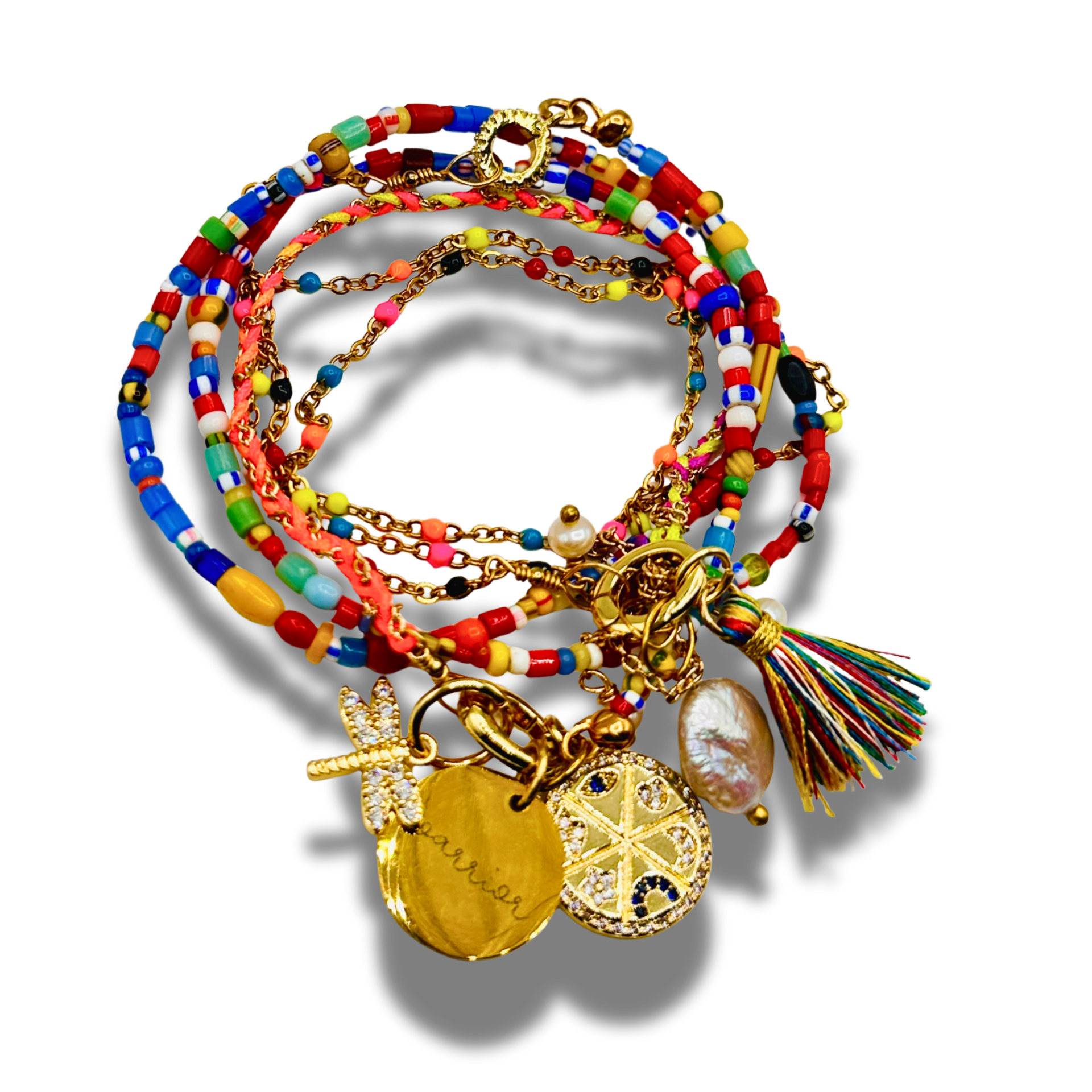 Colorful beaded bracelet with gold charms and tassel on a white background