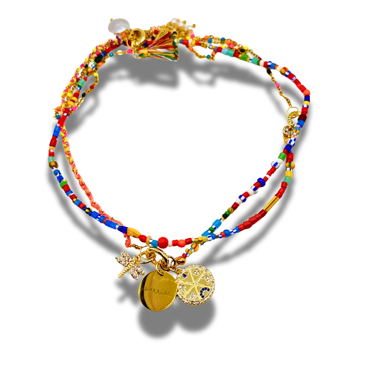 Colorful beaded bracelet with gold charms on a white background