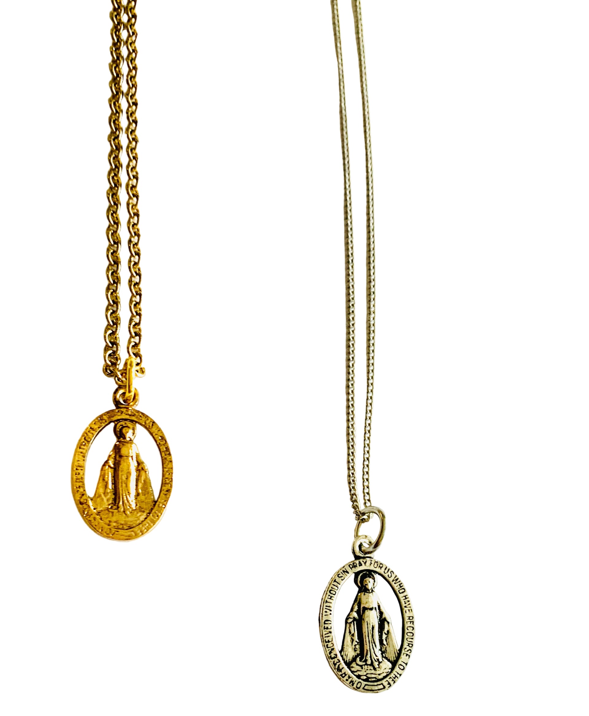 A necklace with a double-sided religious medal, one side in gold plating and the other in silver, attached to an antiqued brass chain.